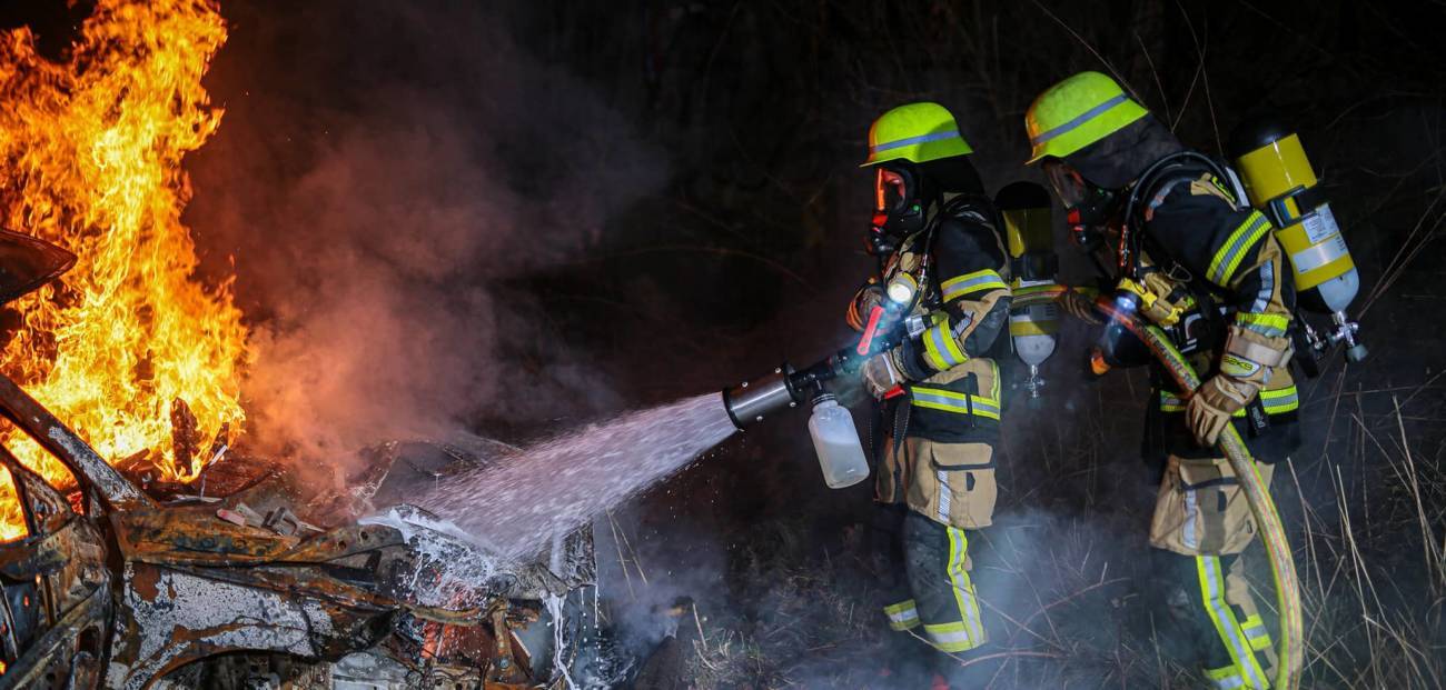 Fire personnel spraying water on a fire